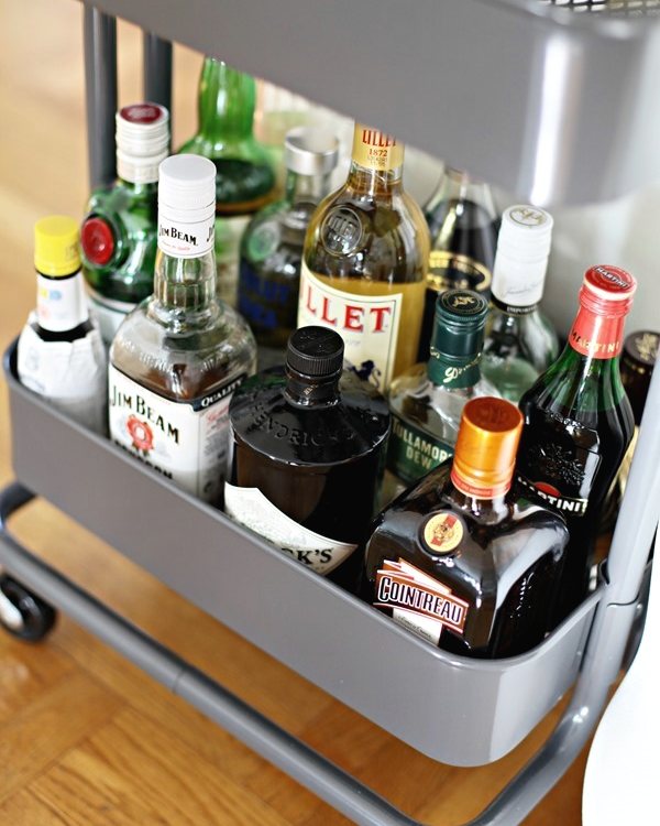 The trolley from above, bottles ranged along the top shelf