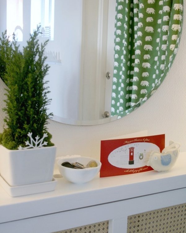 The cover with a plant and mirror above it