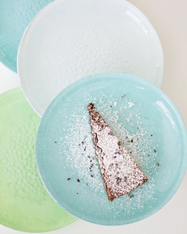 A slice of tart on a pale blue painted glass plate