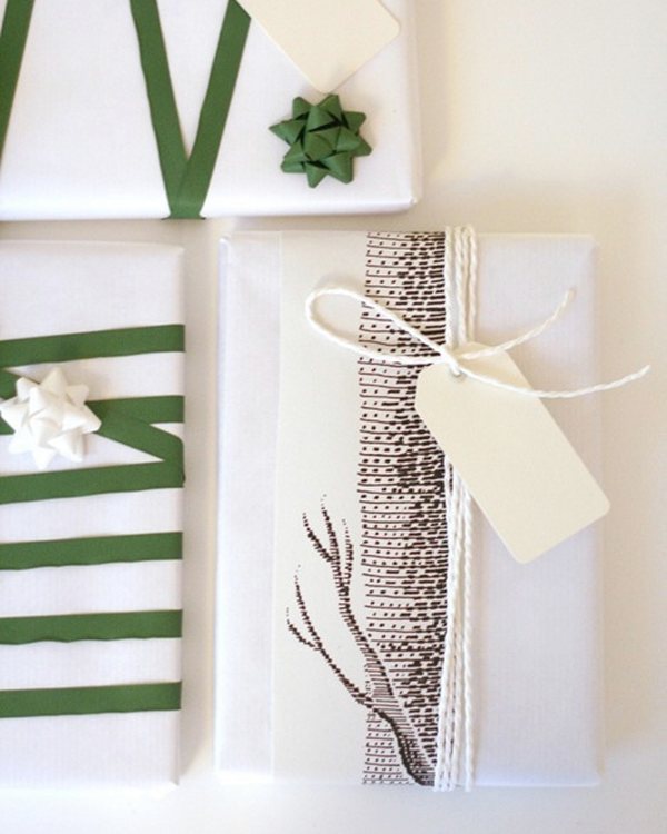 Parcels in white paper with green ribbon and plain tags